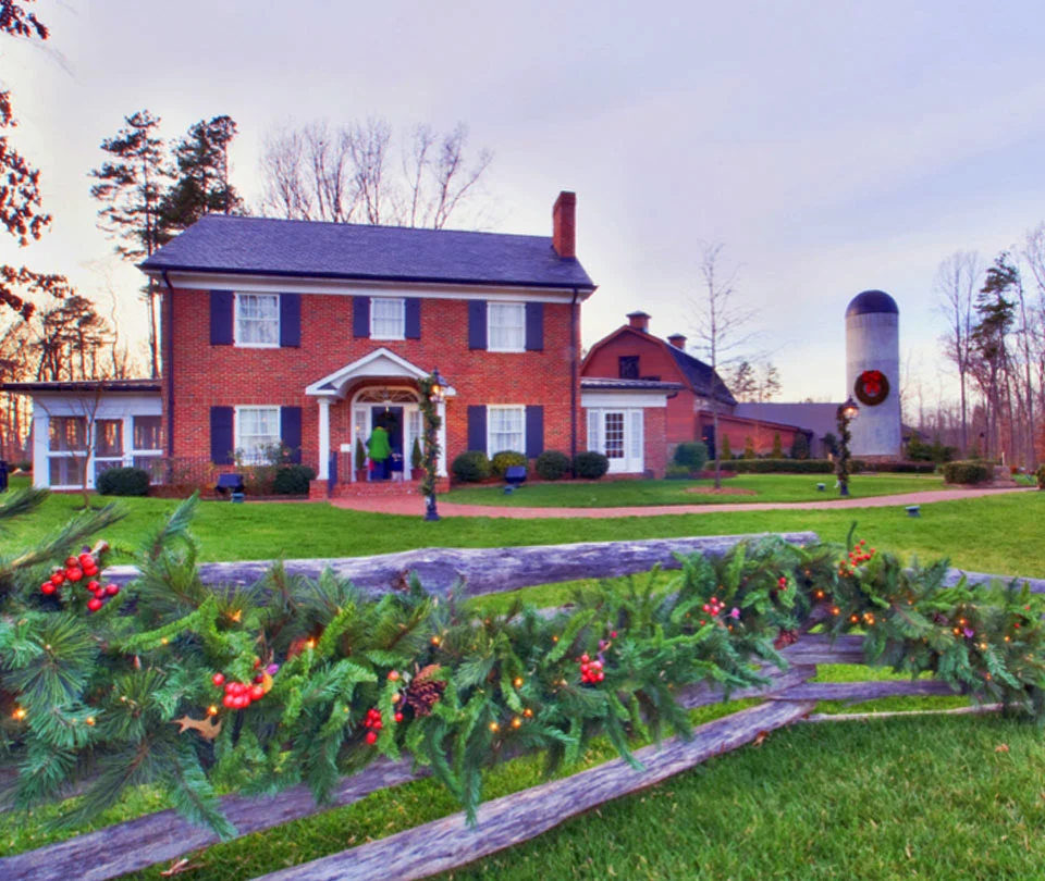 Holiday garland with red berries along a split rail fence at the Billy Graham Library
