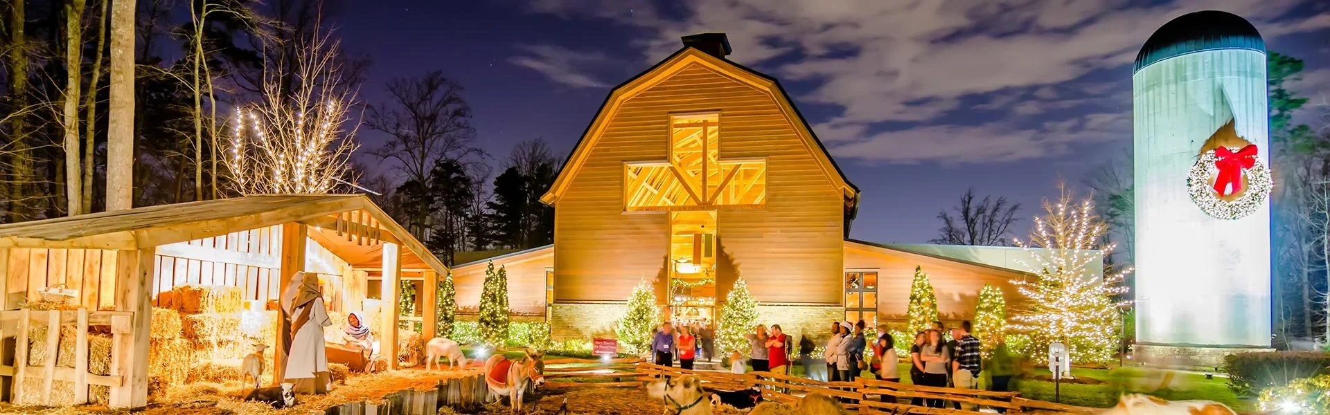 Billy Graham Library courtyard at dusk with Christmas lights and a wreath on the silo