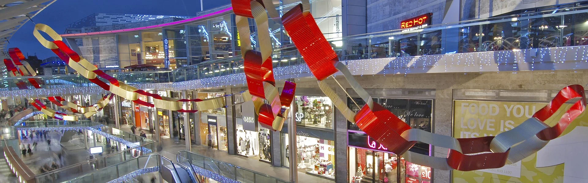 Giant red and white paper chain decorations hanging across a mall atrium