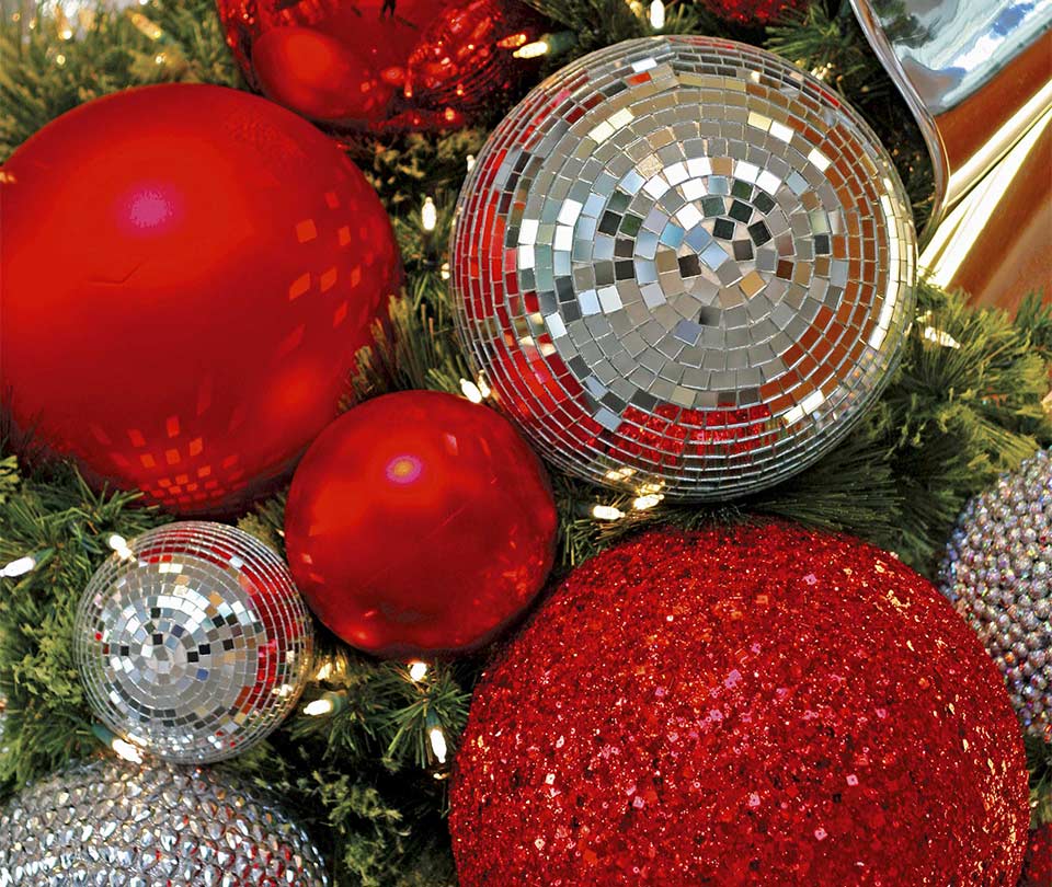 Close up of red and mirrored ball ornaments on garland