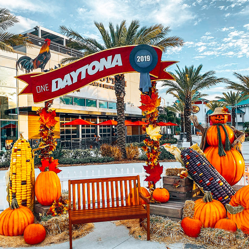 Fall Photo Op Decor for outdoor shopping center with giant corn, pumpkins and scarecrow