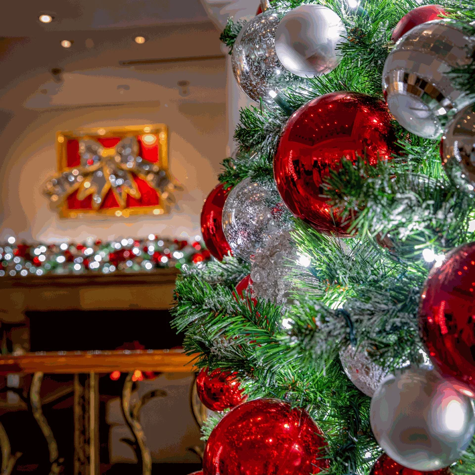 Red and silver ornaments on a Christmas tree in the Fairmont Scottsdale Princess lobby